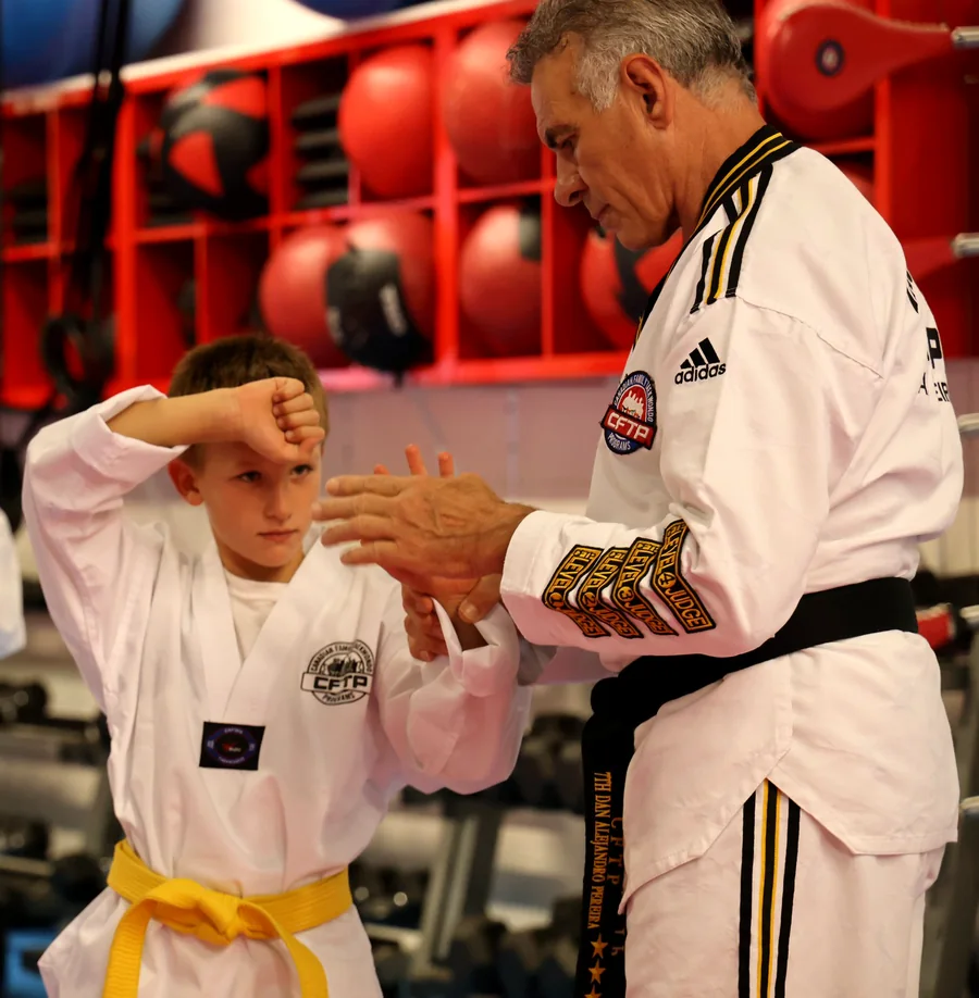 An instructor guiding a young student through a block