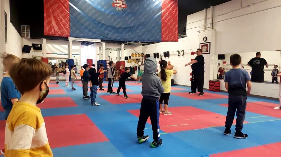 Young children learning a stance in a Lil Lions class
